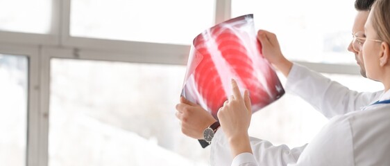 Doctors studying x-ray image of lungs in clinic. Banner for design