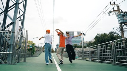 Back view of skilled hipster walking while turn around and looking at camera. Group of professional...