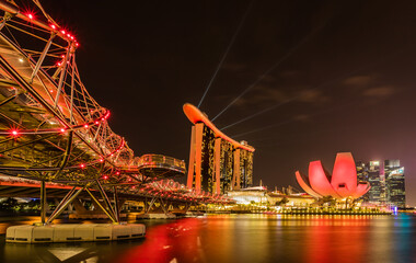 Amidst the vibrant city lights of Singapore, the helix bridge connects the sky and water in a dazzling display of architectural wonder