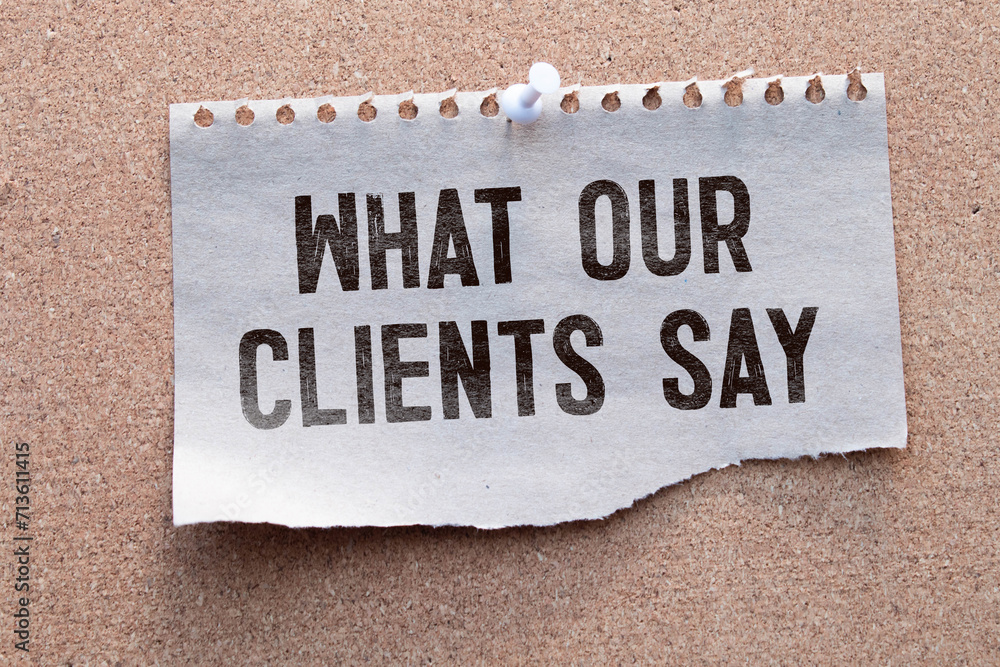 Poster what our clients say statement on paper note pad. office desk with electronic devices and computer, 