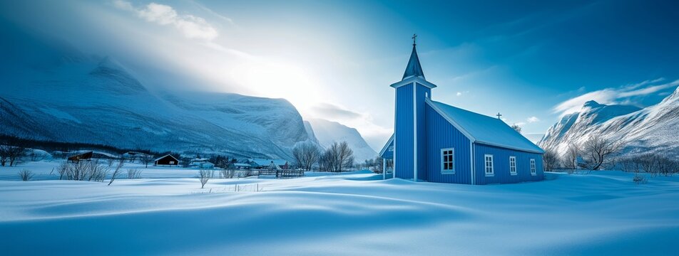 A blue and white chapel amongst the heavy snow laden mountains of Norway.