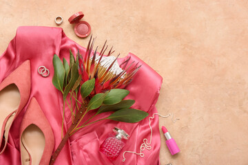 Composition with stylish female accessories, perfume, heels, dress and protea flower on beige...