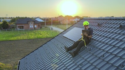Solar engineer monitoring the efficiency and production of energy output of panels on rooftop