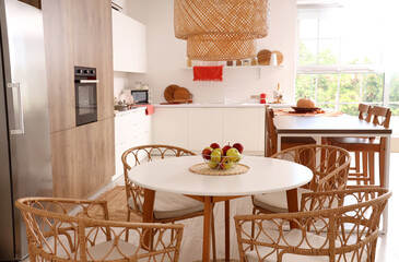 Basket with apples on dining table in modern kitchen