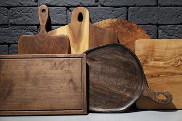 Set of different wooden cutting boards on table