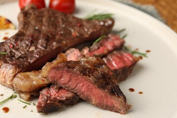 Delicious grilled beef steak on plate, closeup