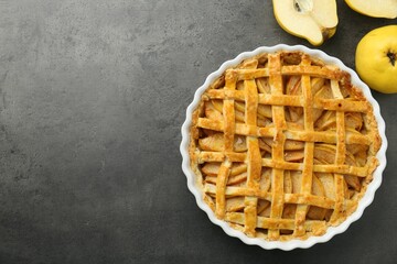 Tasty homemade quince pie and fresh fruits on grey table, flat lay. Space for text