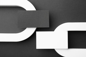 Stylish presentation of blank business cards on black background, flat lay. Mockup for design