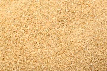 Granulated brown sugar as background, top view