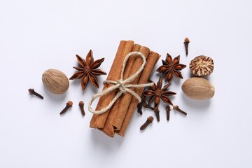 Different spices and nuts on white background, flat lay