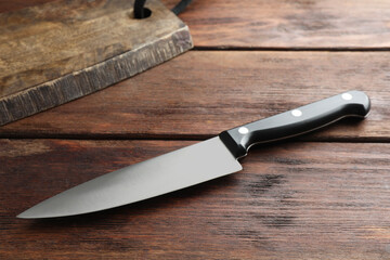 One sharp knife on wooden table, closeup
