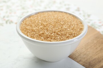 Brown sugar in bowl on table, closeup