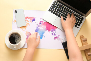 Female hands with modern laptop, mobile phone and world map on color background