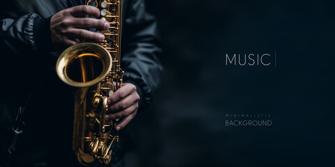 Music banner. Close-up of hands playing a golden saxophone against a dark backdrop. - obrazy, fototapety, plakaty