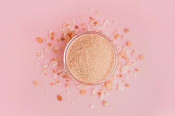 Glass bowl with Himalayan pink salt on pink background