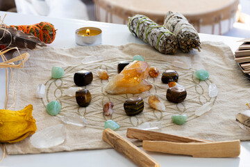 A close up image of a crystal healing grid using sacred geometry and raw citrine crystals with a meditation drum in the background. 