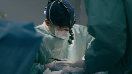 Team surgeons perform operation in operating room professional doctor practitioner using modern medical endoscopic instruments heart surgery remove cancer tumor surgical health procedure in hospital - Powered by Adobe