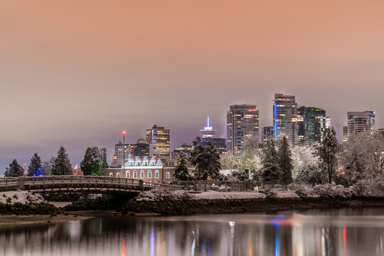 Canada Place, City Skyline, Urban Downtown Cityscape. Vancouver, British Columbia, Canada. Winter Night Sky after a snowfall. View from Stanley Park.