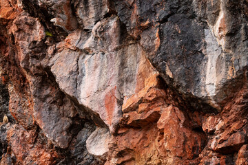 A colorful rock wall next to Kiutaköngäs rapids in Oulanka National Park, Northern Finland