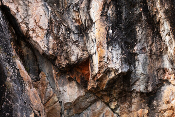 A colorful rock wall next to Kiutaköngäs rapids in Oulanka National Park, Northern Finland