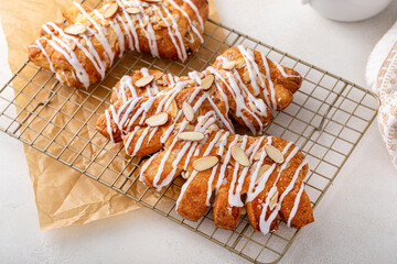 Bear claws pastry topped with glaze and almonds