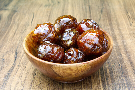 Amla Murabba in a wooden bowl Side view 