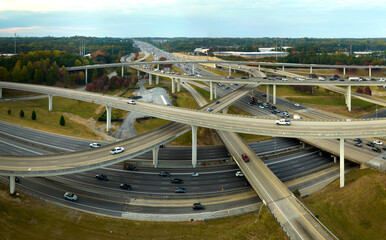 American freeway intersection with fast driving cars and trucks. View from above of USA...