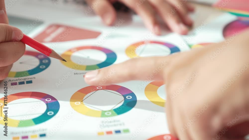 Aufkleber slow motion hand closeup of two designer brainstorming and choosing color for graphic design working