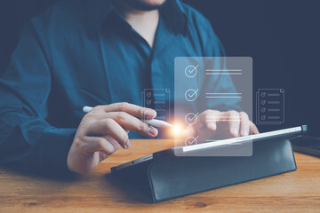 Checklist, Digital and smart checklist document concept, Businessman marking on e-checklist on virtual screen and use laptop document management with modern intelligent online systems high security.
