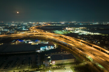 Fototapeta na wymiar View from above of american big freeway intersection in Tampa, Florida at night with fast moving cars and trucks. USA transportation infrastructure concept