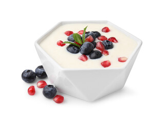 Naklejka na ściany i meble Bowl of delicious semolina pudding with blueberries, pomegranate and mint isolated on white
