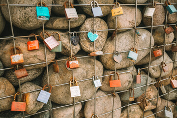 Locks of lovers and newlyweds on the embankment.Love and fidelity symbol. Metal locks on a grid...