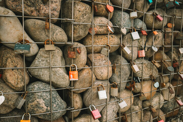  locks on a grid with stones on the promenade by the sea. Customs and traditions of lovers and...