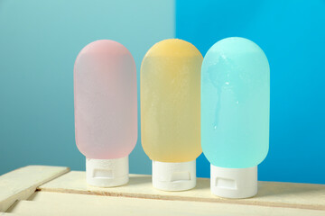 Cosmetic travel kit on wooden table. Bath accessories