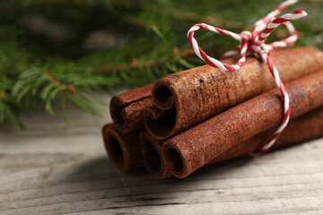 Cinnamon sticks on wooden table, closeup view