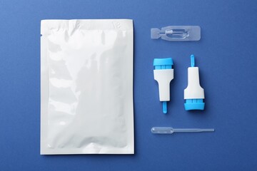 Disposable express test kit on blue background, flat lay