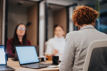Creative business team discussing digital marketing strategy for sales growth. Multiracial colleagues collaborating on market analysis and financial statements in the office.