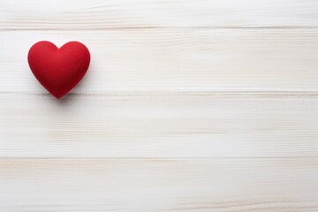 Overhead shot of a small red heart on a white wooden background - romantic concept, copy space - generative ai