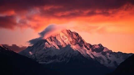 A breathtaking mountain landscape at sunset, with snow-capped peaks, a fiery sky, and a sense of awe and majesty, Photography