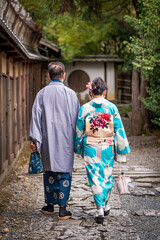 Senior couple wearing kimono, back view.