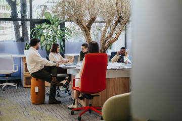 A diverse group of business people collaborating in a corporate office, discussing ideas and strategizing for success.