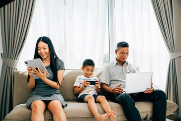 At home an Asian family's device obsession overshadows bonding time. Parents and kids immersed in...