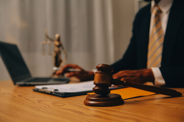 Judge gavel with Justice lawyers having team meeting at law firm background. Concepts of Law and Legal services.