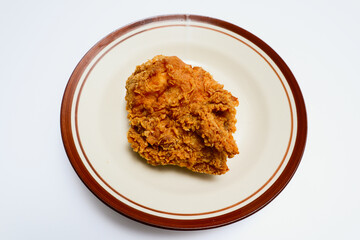 fried chicken on a plate, isolated over white background