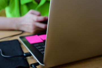 Fototapeta premium a woman's hand playing mobile phone while working
