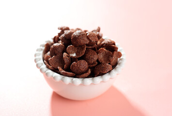 Chocolate Cereals in White Bowl. Chocolate Flavored Corn Flakes.
