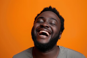 Close up of man's carefree laughter, orange studio environment