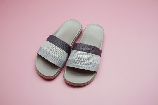Gray slide sandal summer slippers on pink background