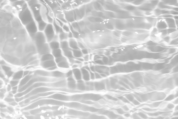 White water with ripples on the surface. Defocus blurred transparent white colored clear calm water surface texture with splashes and bubbles. Water waves with shining pattern texture background.