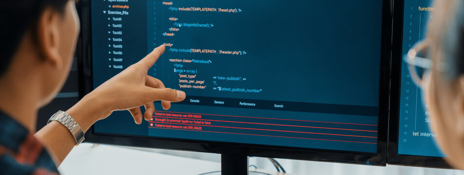 Female programer explain while pointing code displayed on computer. Professional programmer present data analysis and writing java script at modern company office. Closeup. Burgeoning.